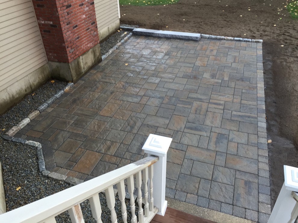 Example of a mid-sized minimalist backyard concrete paver patio design in Boston with no cover