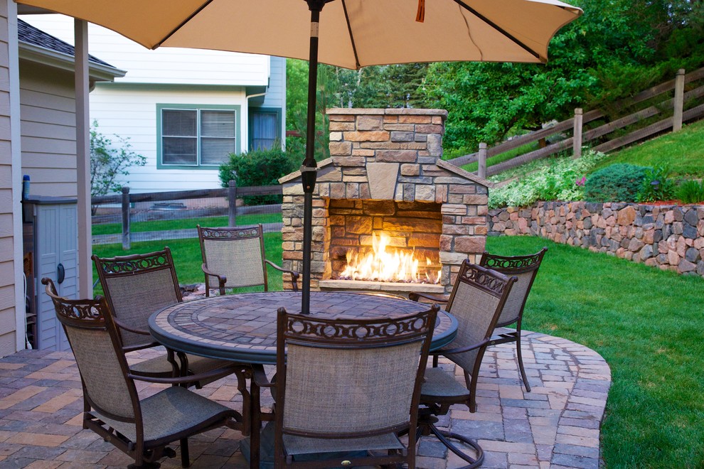 Inspiration for a medium sized rustic back patio in Denver with a fire feature, brick paving and no cover.