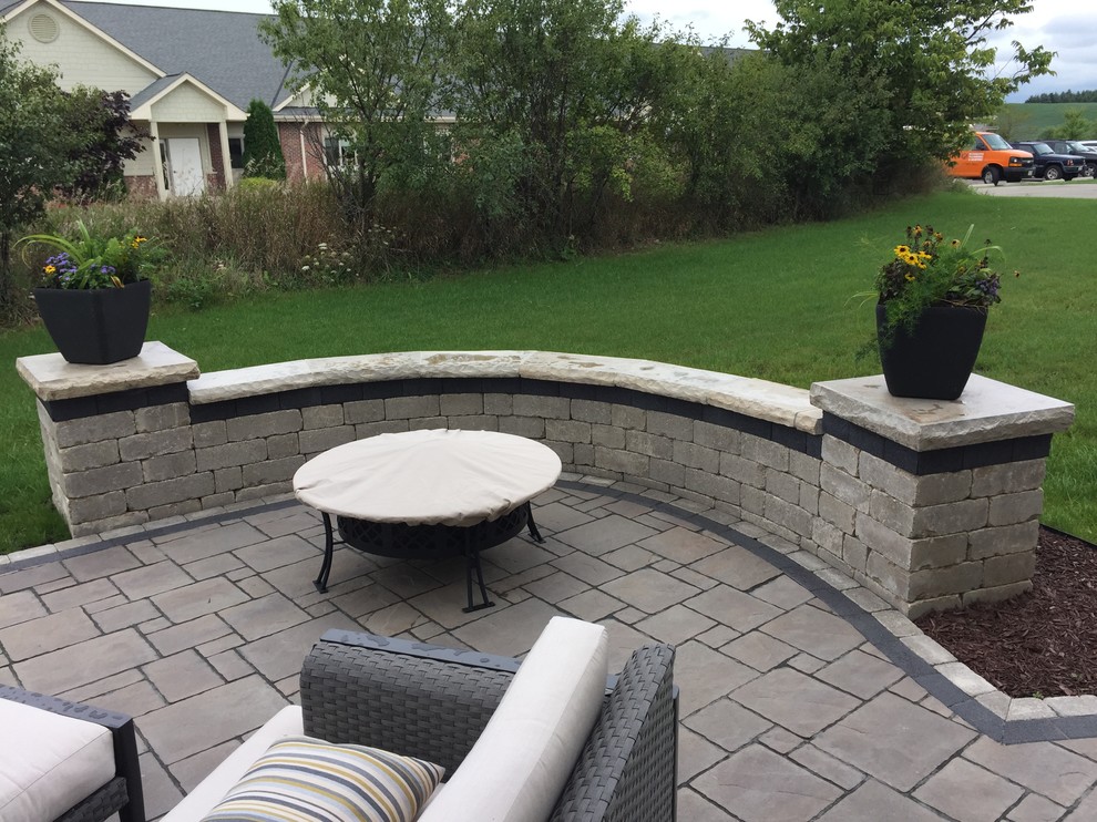 Design ideas for a medium sized classic back patio in Milwaukee with natural stone paving.