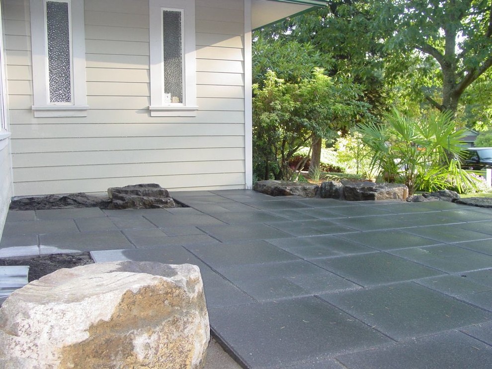 Medium sized modern back patio in Portland with concrete paving.