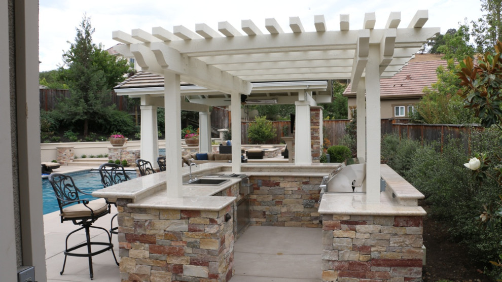 Design ideas for a large traditional back patio in San Francisco with an outdoor kitchen, concrete paving and a pergola.