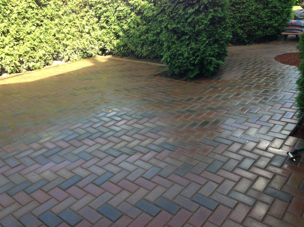 Design ideas for a medium sized modern back patio in Montreal with brick paving.