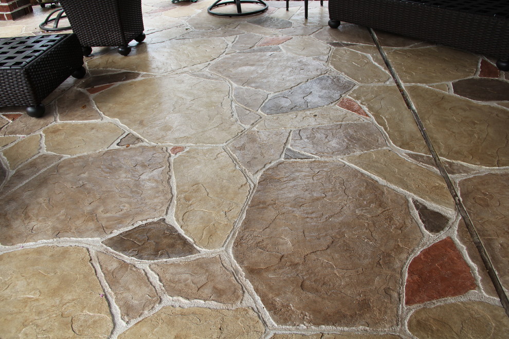 Inspiration for a mid-sized timeless backyard stamped concrete patio remodel in Houston with a fire pit and a roof extension