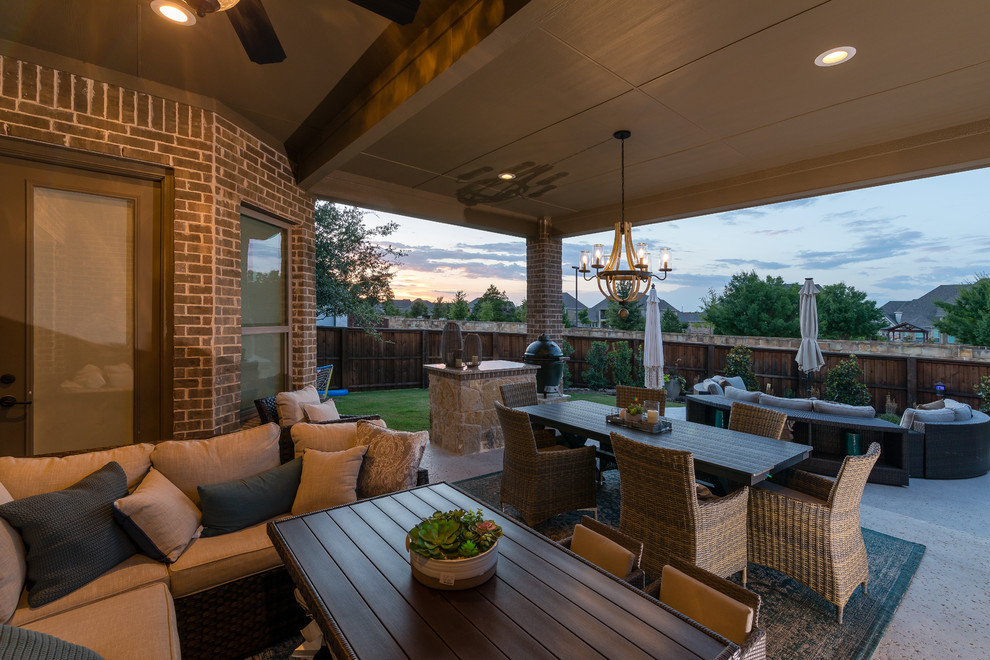 Mid-sized transitional backyard concrete patio photo in Dallas with a fire pit and a roof extension