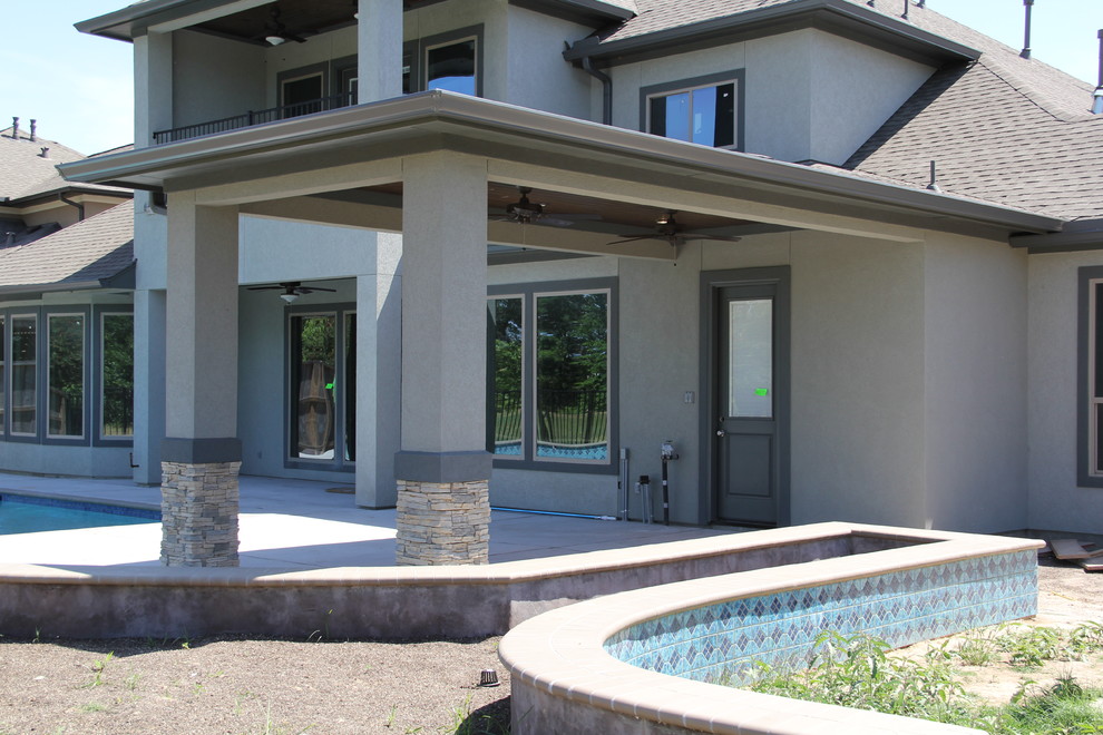 Inspiration for a mid-sized contemporary backyard stamped concrete patio remodel in Houston with a roof extension