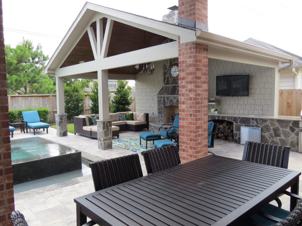Large trendy backyard stamped concrete patio kitchen photo in Houston with a gazebo