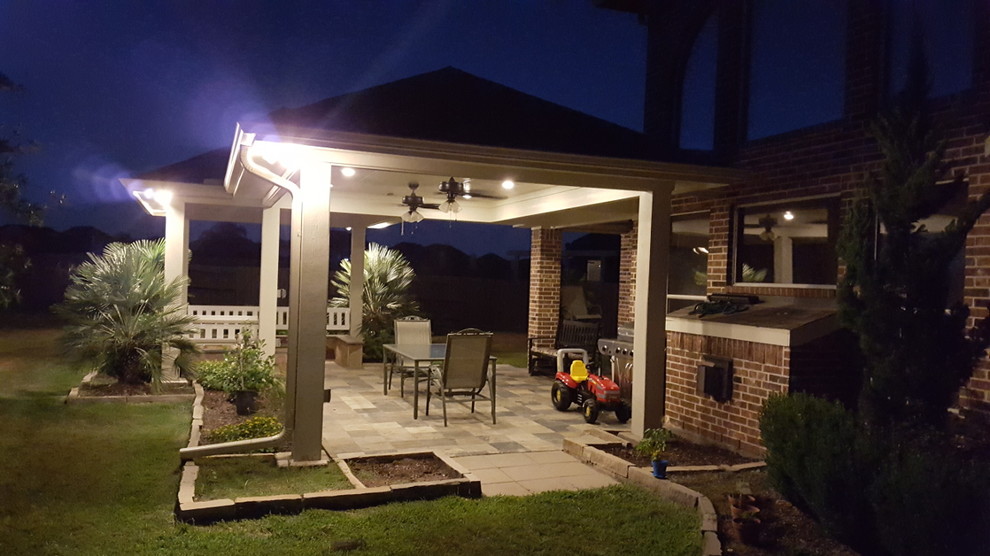 Inspiration for a mid-sized timeless backyard patio remodel in Houston with a fire pit and a roof extension