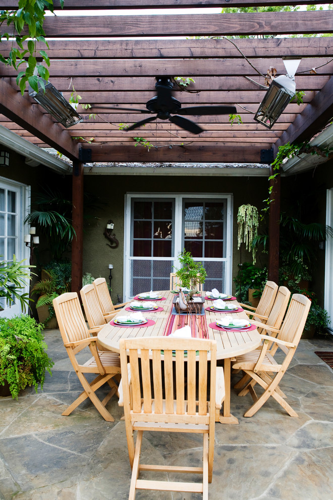 Example of a trendy patio design in Los Angeles with a pergola