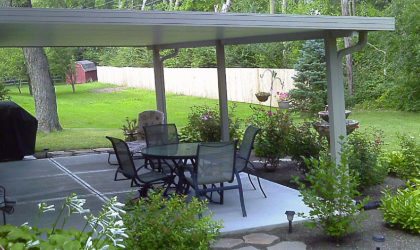 Photo of a medium sized classic back patio in Other with concrete paving and a roof extension.