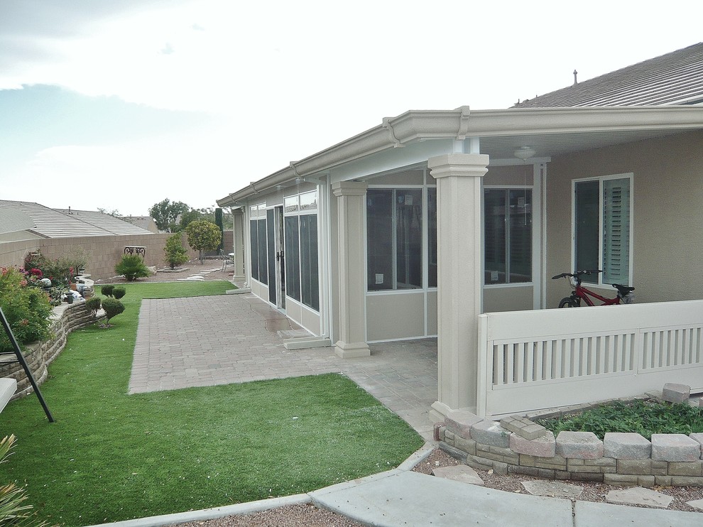 Arts and crafts backyard concrete patio photo in Las Vegas with an awning
