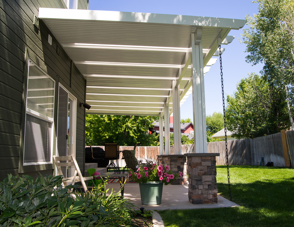 Inspiration for a modern patio in Boise with an awning.