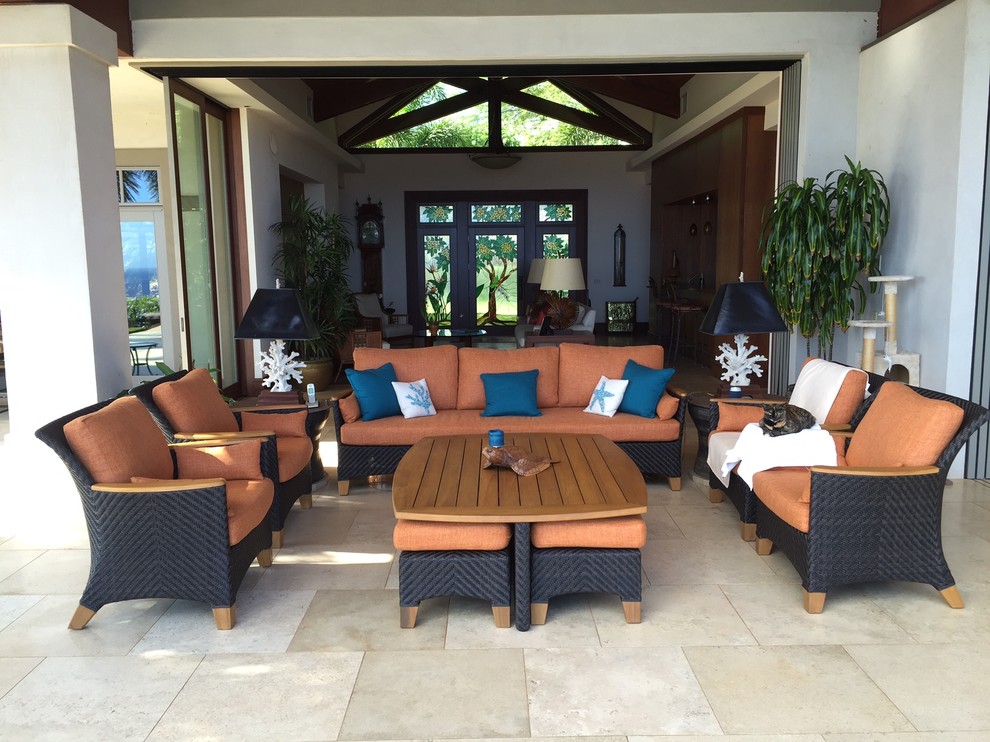 Design ideas for a medium sized world-inspired back patio in Hawaii with stamped concrete and a roof extension.