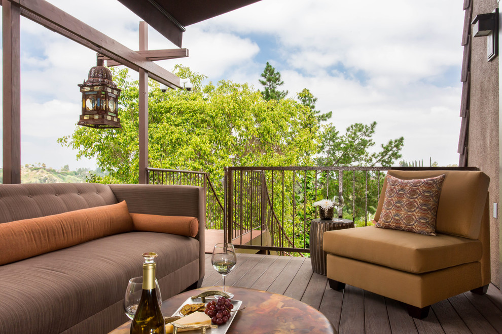 Inspiration for a large mediterranean patio remodel in Los Angeles with decking and an awning