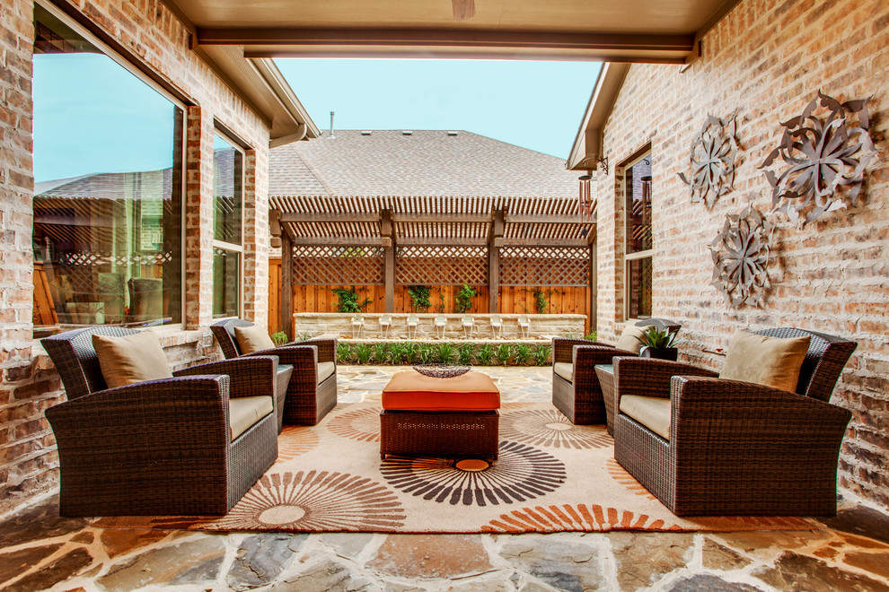 Classic patio in Dallas with natural stone paving and a roof extension.