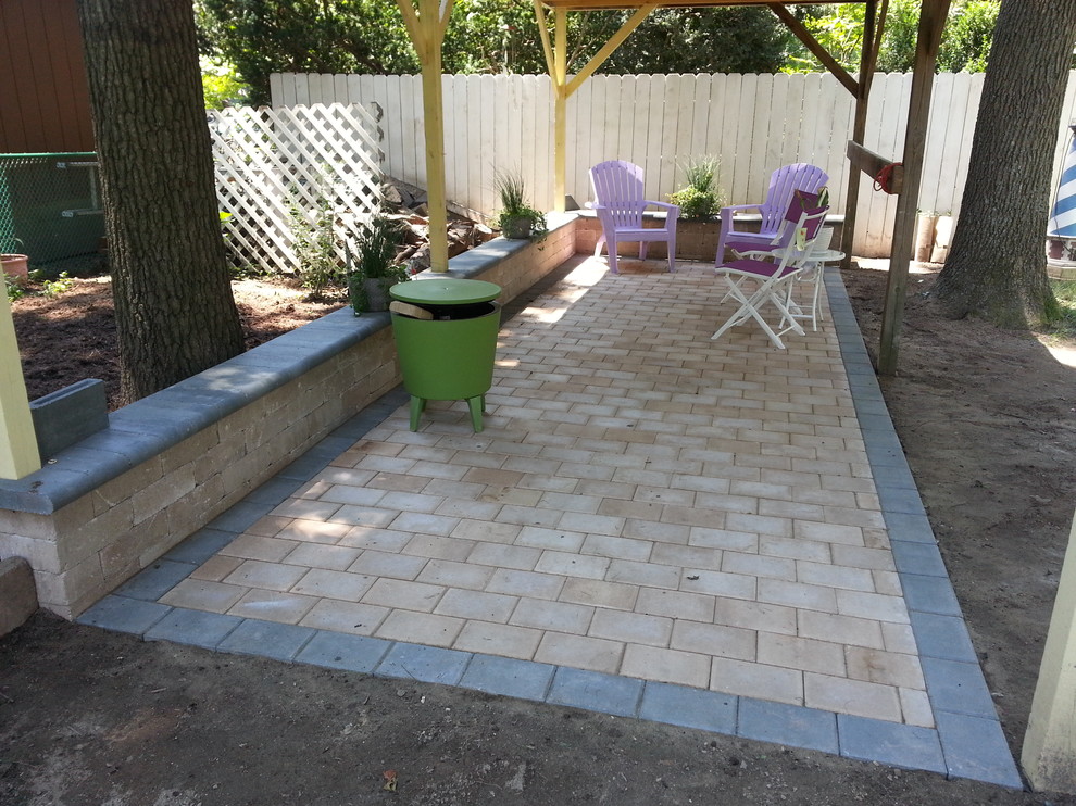 Small traditional back patio in Baltimore with brick paving and no cover.