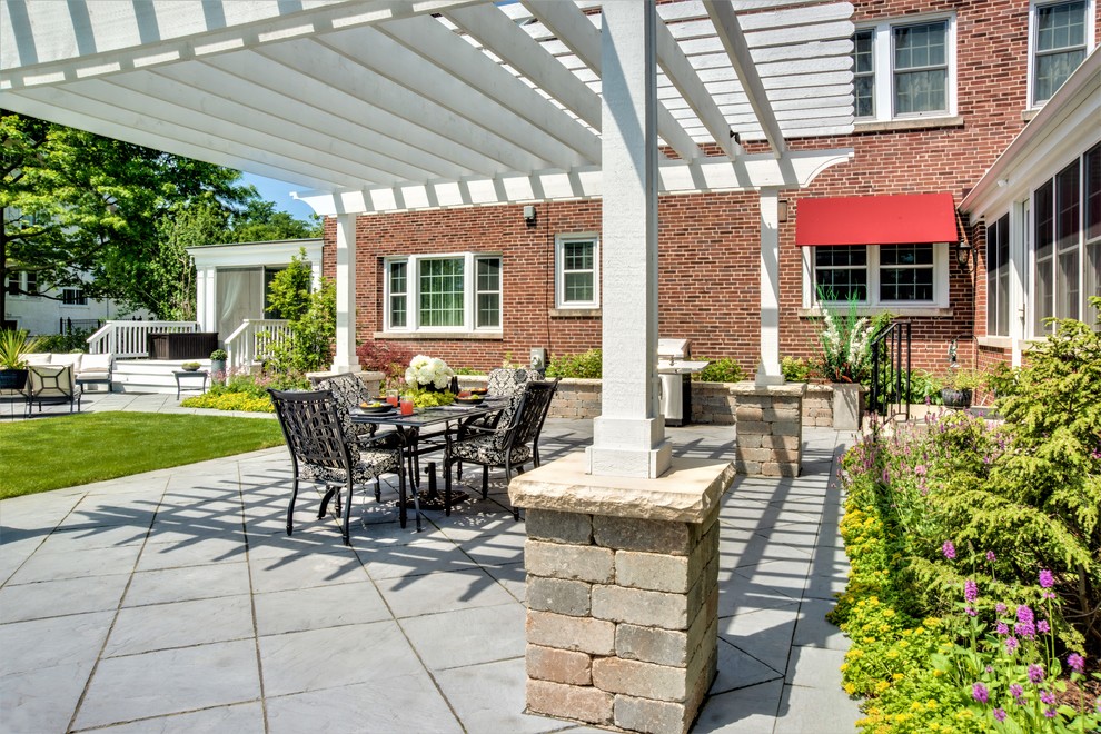 Patio - large transitional backyard stone patio idea in Chicago with a fire pit and a pergola