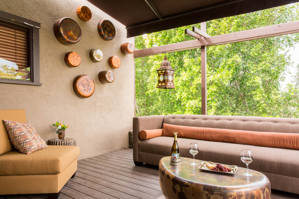 Example of a large tuscan patio design in Los Angeles with decking and an awning