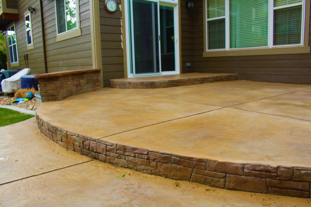 Patio overlay with vertical stacked stone seating walls Traditional