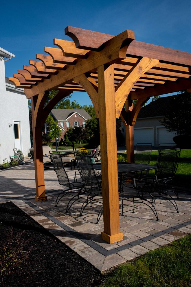 Patio - mid-sized traditional backyard stone patio idea in Columbus with a fire pit and a pergola