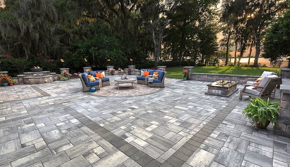Large transitional backyard stamped concrete patio photo in Tampa with a fire pit and no cover