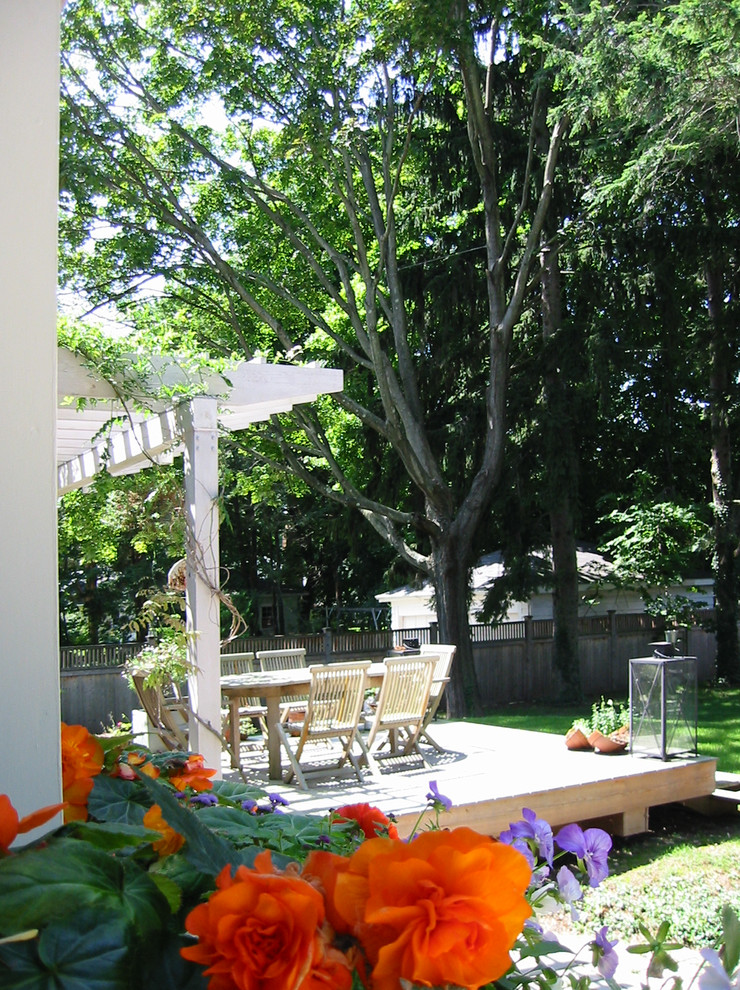 Design ideas for an eclectic back patio in New York with a pergola.