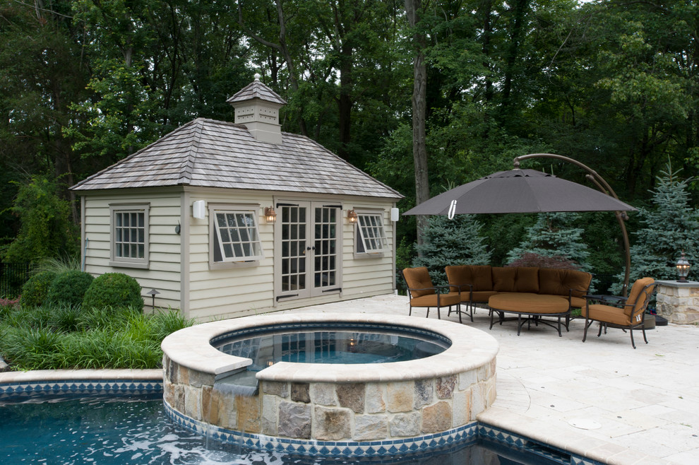 This is an example of an expansive traditional back patio in New York with a water feature, decking and a gazebo.