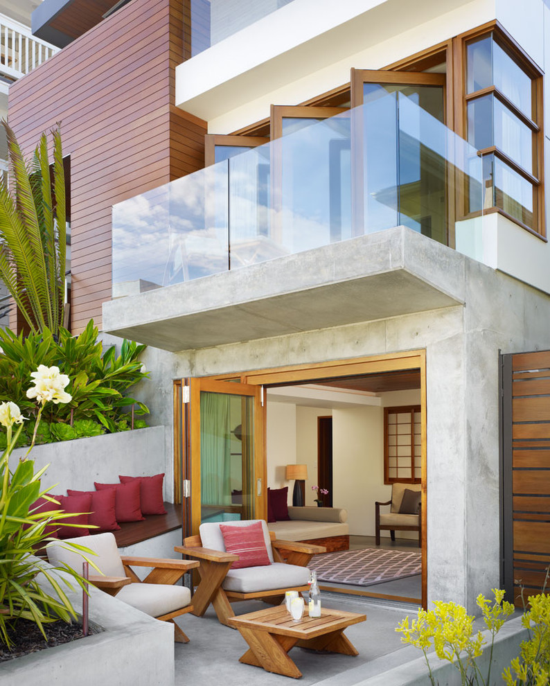 Inspiration for a mid-sized tropical front yard concrete patio remodel in Los Angeles with no cover
