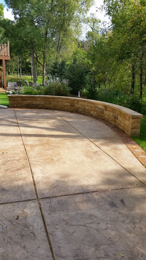 This is an example of a medium sized classic patio in Minneapolis with concrete slabs.
