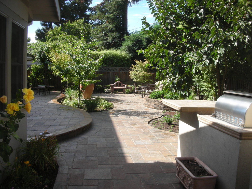 Design ideas for an expansive classic back patio in San Francisco with brick paving and no cover.