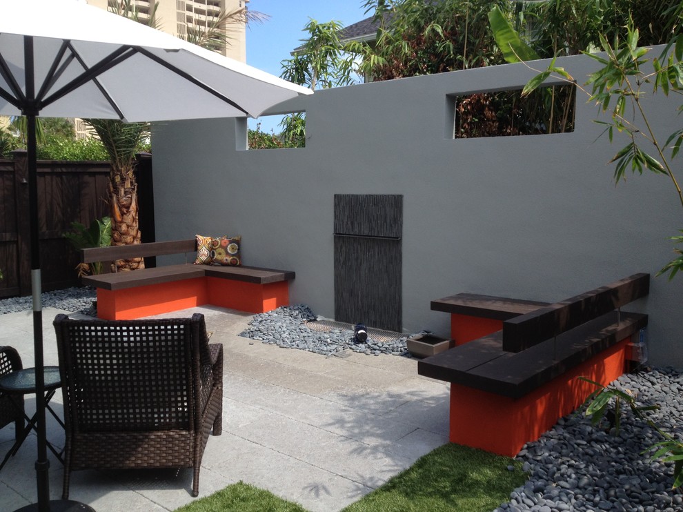 Patio fountain - small backyard concrete paver patio fountain idea in Jacksonville with no cover