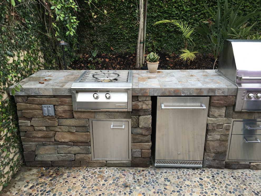 Inspiration for a medium sized classic back patio in Orange County with an outdoor kitchen, concrete slabs and no cover.