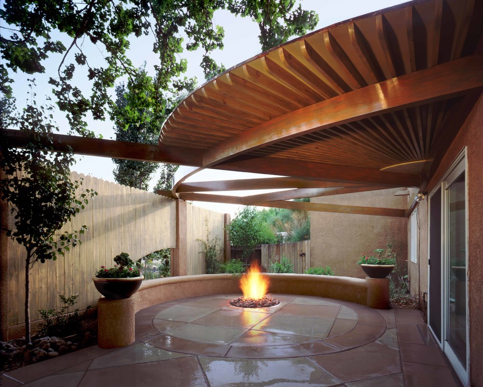 Inspiration for a small classic courtyard patio in Albuquerque with a fire feature, stamped concrete and a pergola.