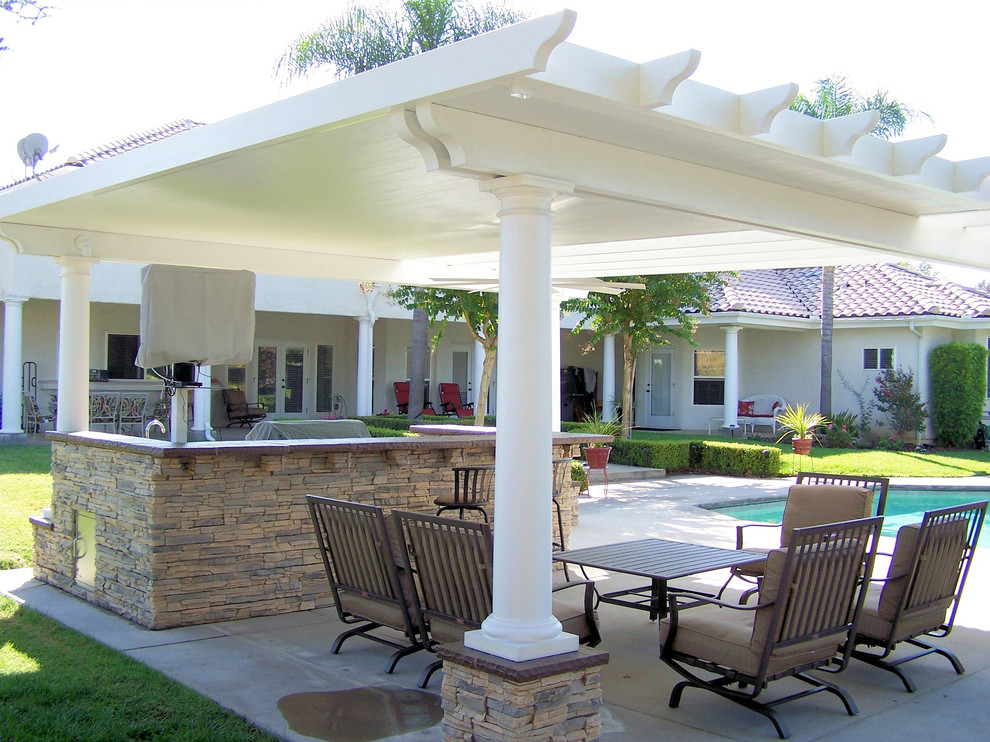 Design ideas for a medium sized mediterranean back patio in Other with concrete slabs and a pergola.