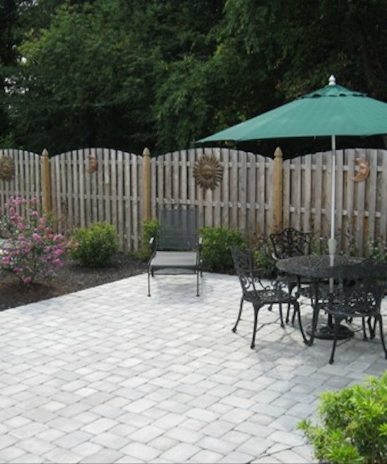 This is an example of a small back patio in Philadelphia with brick paving.