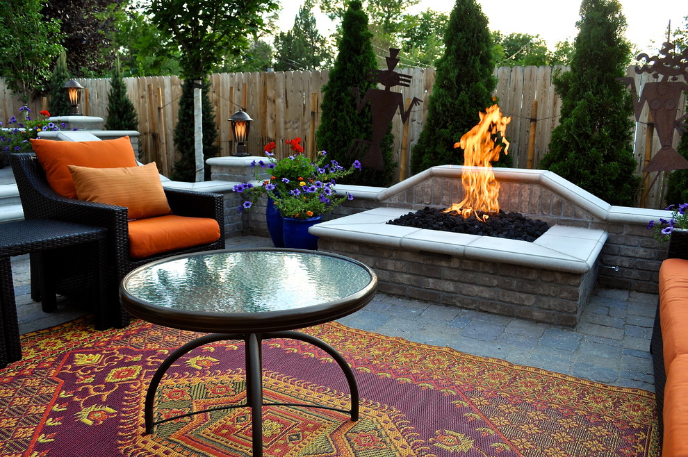 Inspiration for a medium sized classic back patio in Denver with a fire feature, concrete paving and no cover.