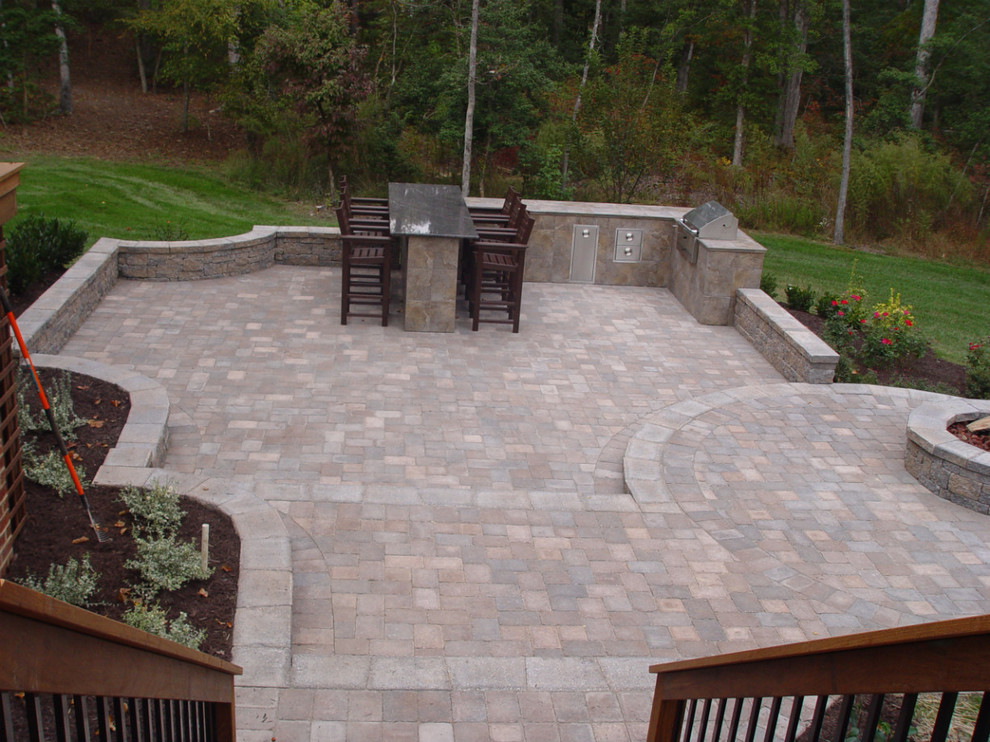 Example of a large classic backyard brick patio kitchen design in Richmond with no cover