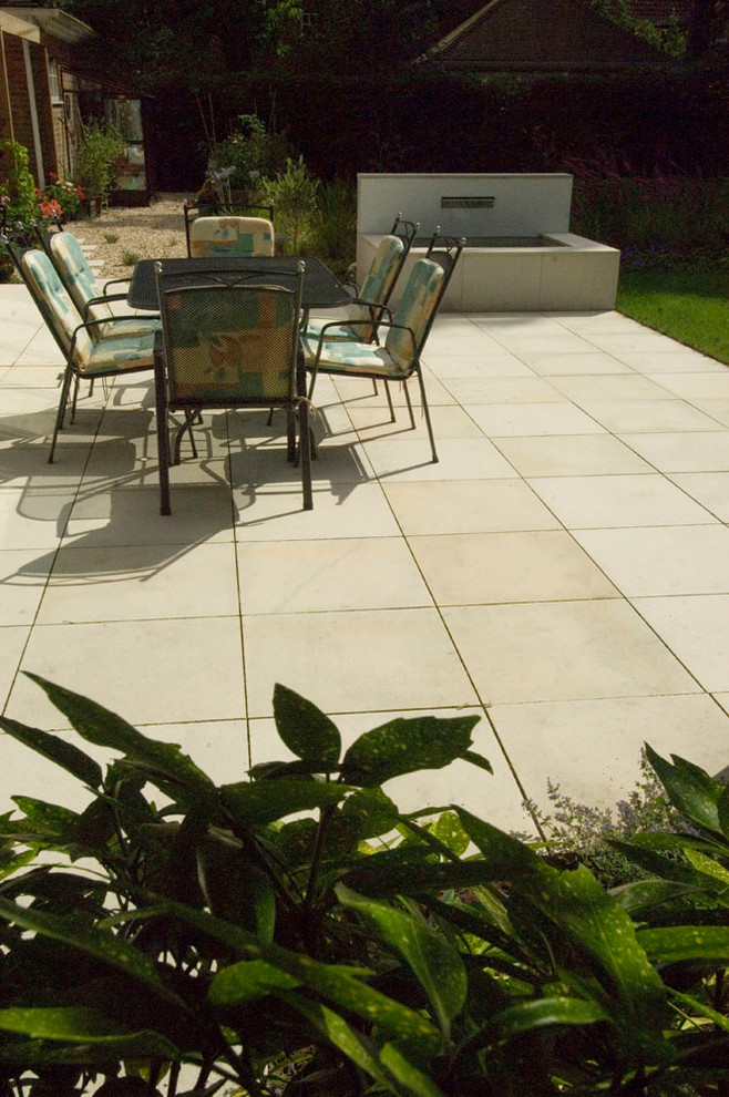 This is an example of a contemporary patio in Oxfordshire with natural stone paving.