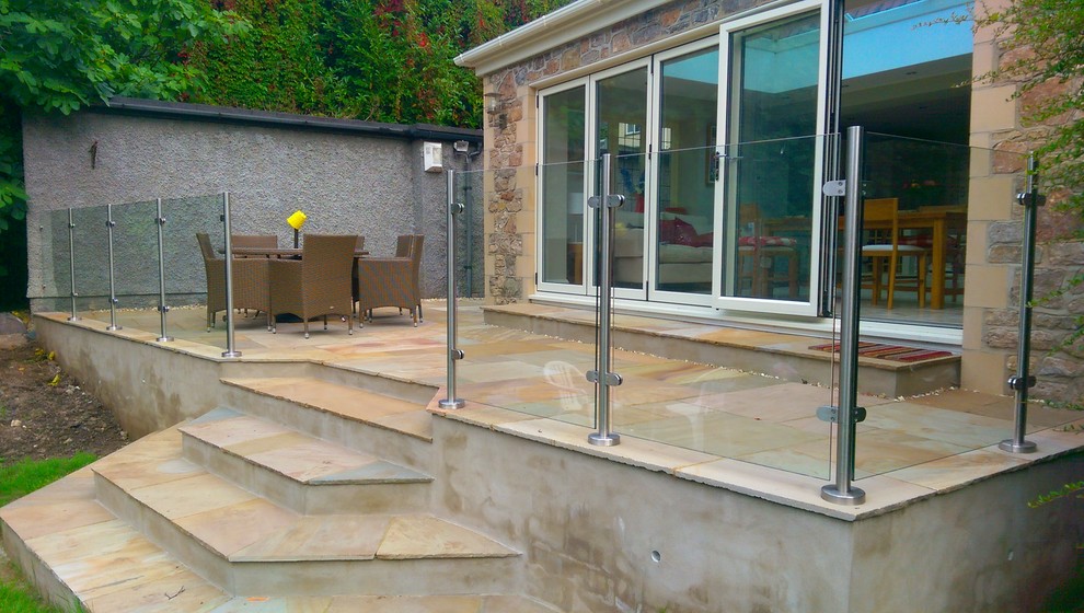 Medium sized back patio in Other with concrete slabs and no cover.