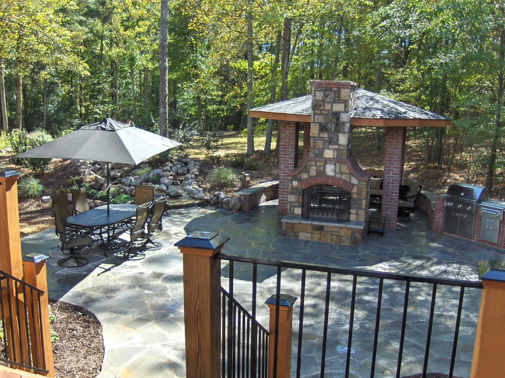 Mid-sized elegant backyard stone patio kitchen photo in Atlanta with a gazebo
