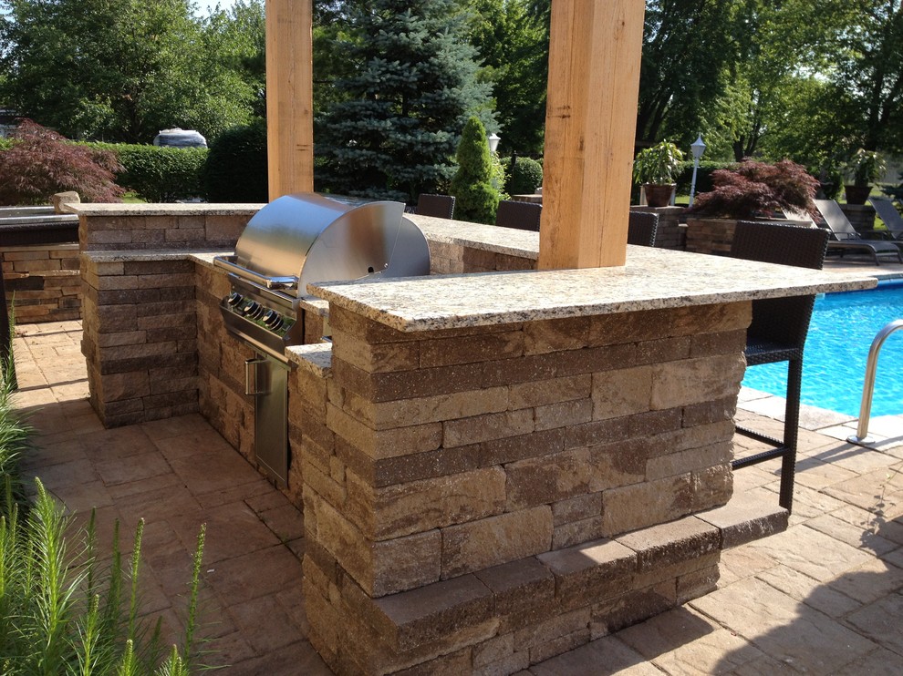 Patio kitchen - mid-sized traditional backyard concrete paver patio kitchen idea in Columbus with a pergola