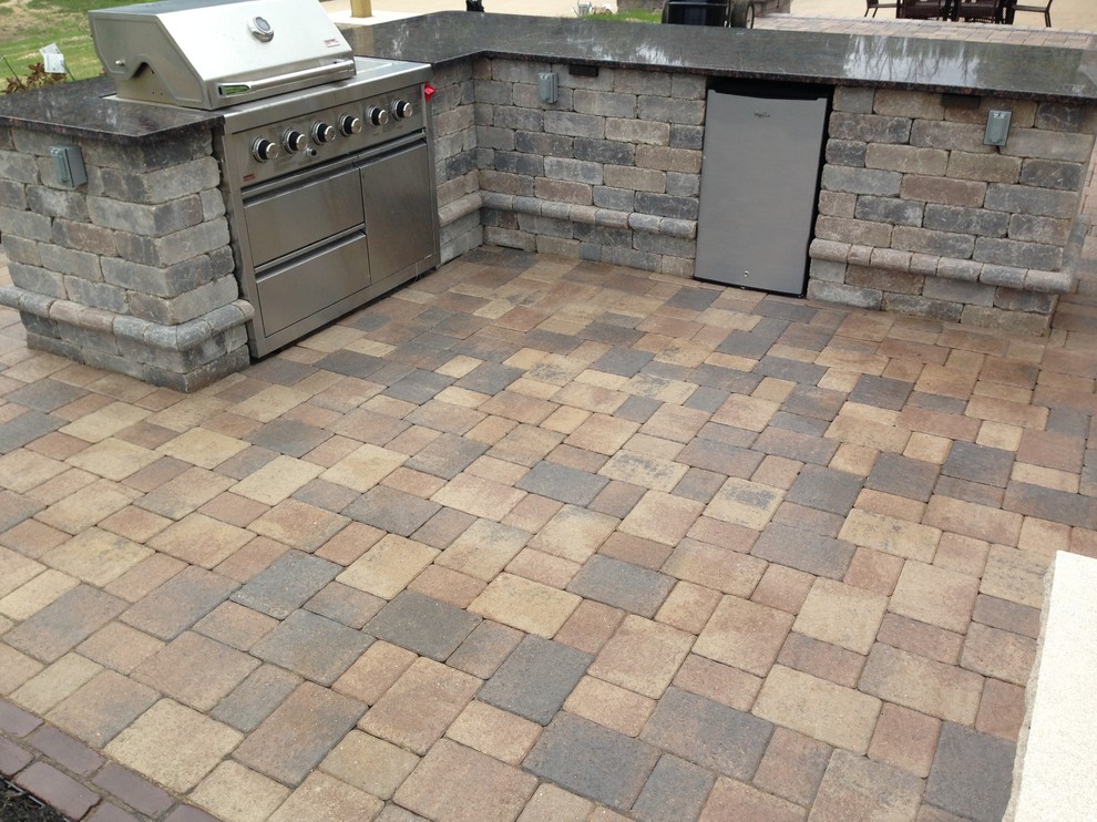 Inspiration for a large traditional side patio in Chicago with an outdoor kitchen, concrete paving and a pergola.