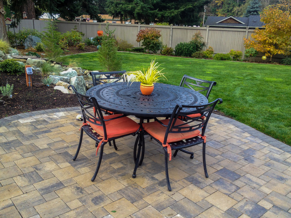 Mid-sized elegant backyard brick patio photo in Seattle with no cover