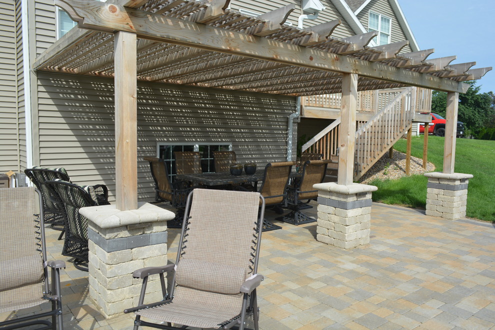 Photo of a medium sized traditional side patio in Chicago with concrete paving and an awning.