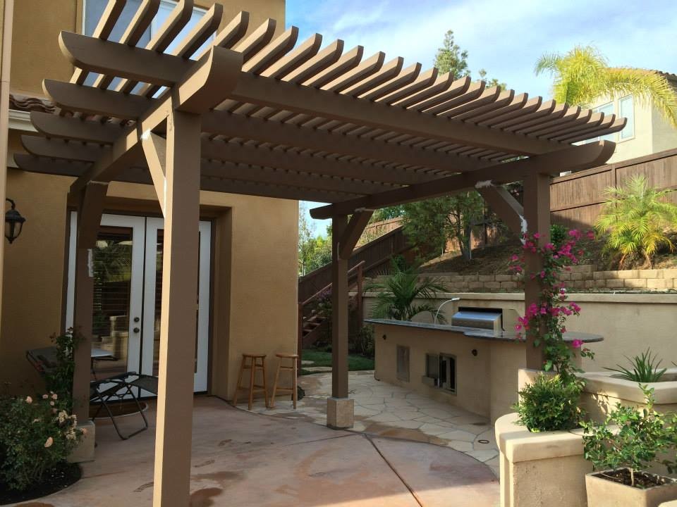 Inspiration for a large transitional backyard brick patio kitchen remodel in San Diego with a pergola