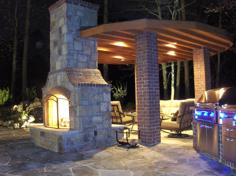 Inspiration for a large timeless backyard stone patio remodel in Atlanta with a fire pit and a pergola