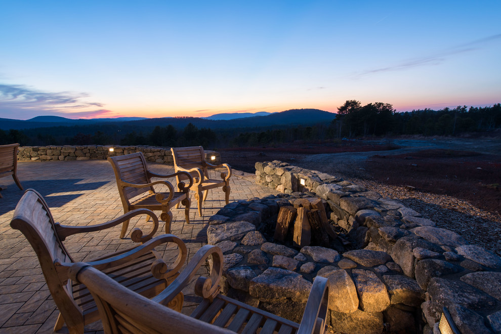 Inspiration for a large transitional backyard patio remodel in Burlington with a fire pit and no cover