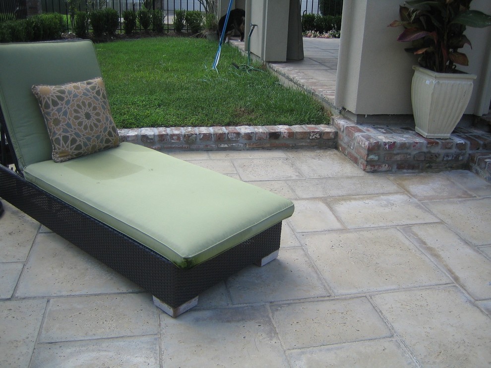 Photo of a medium sized mediterranean back patio in Miami with concrete paving and a roof extension.