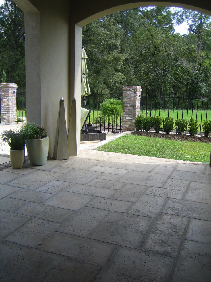Inspiration for a mid-sized mediterranean backyard concrete paver patio remodel in Miami with a roof extension
