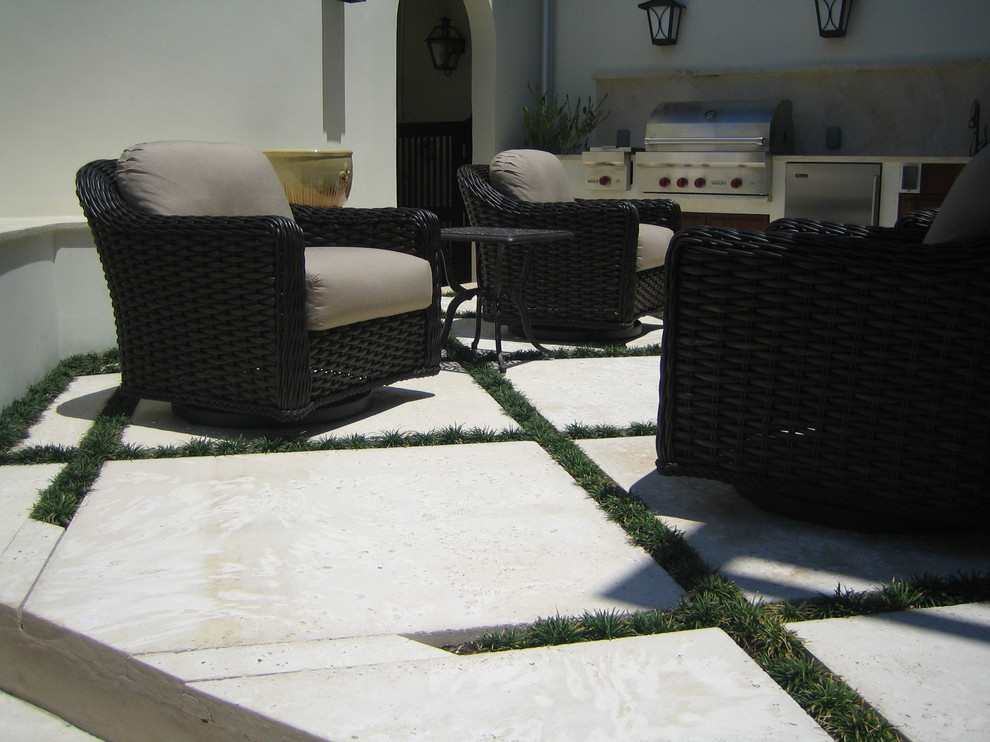 Photo of a large mediterranean back patio in Miami with concrete paving and no cover.