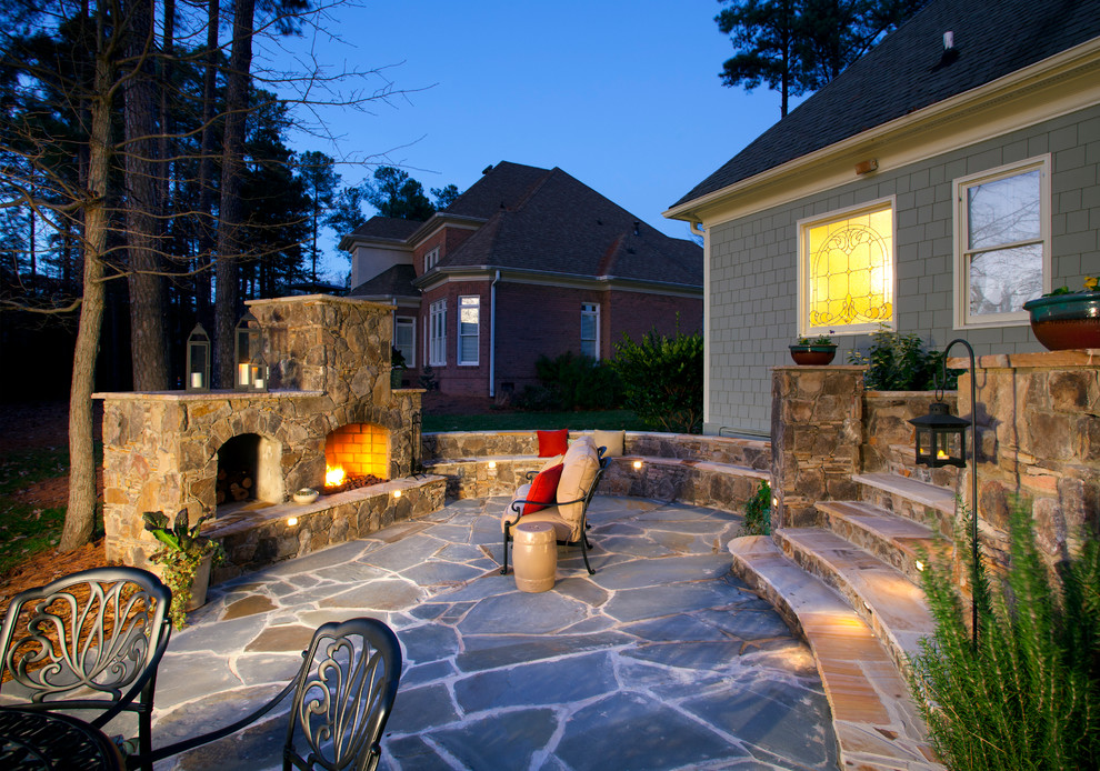 Design ideas for a medium sized classic back patio in Charlotte with natural stone paving, no cover and a fireplace.
